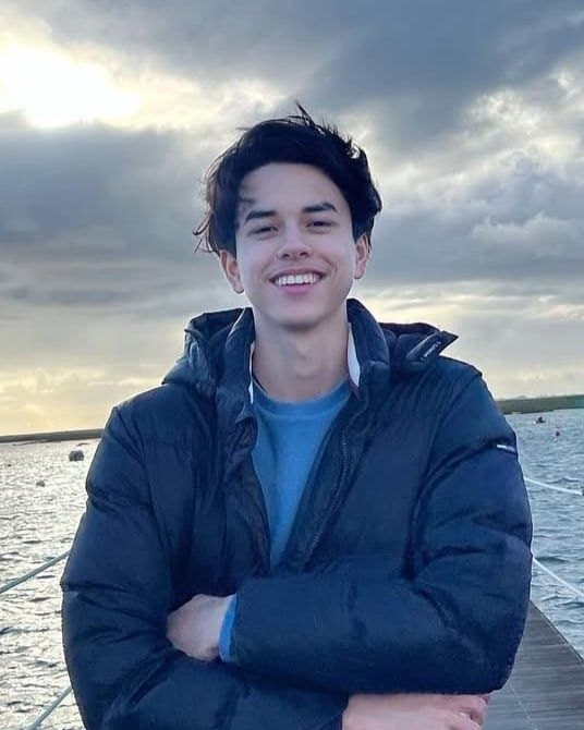 Yannick Seelig on a pier by the water